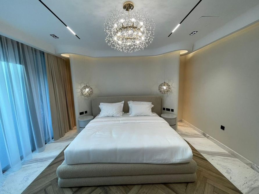 Primary bedroom suite with crystal chandelier
